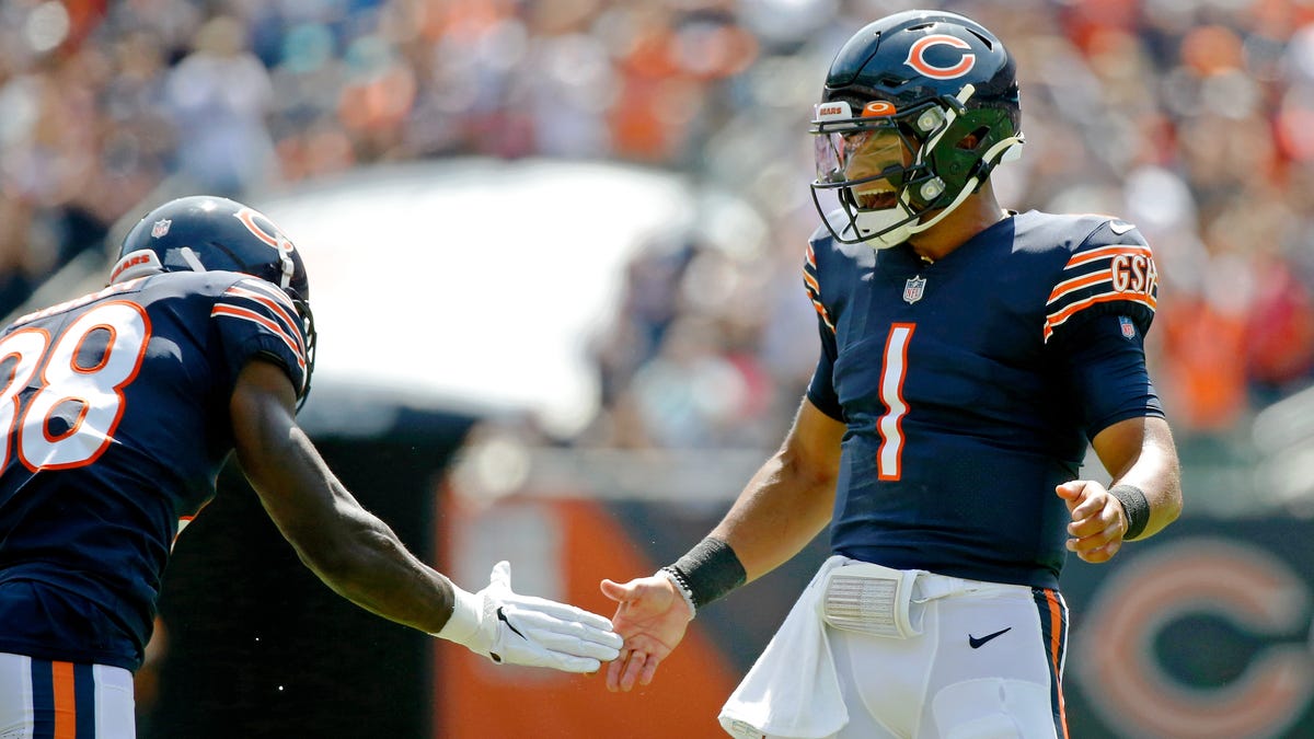 Chicago Bears quarterback Justin Fields (1) celebrates with wide receiver Riley Ridley (88) after throwing a touchdown pass to tight end Jesse James (not pictured) against the Miami Dolphins during the second half at Soldier Field.