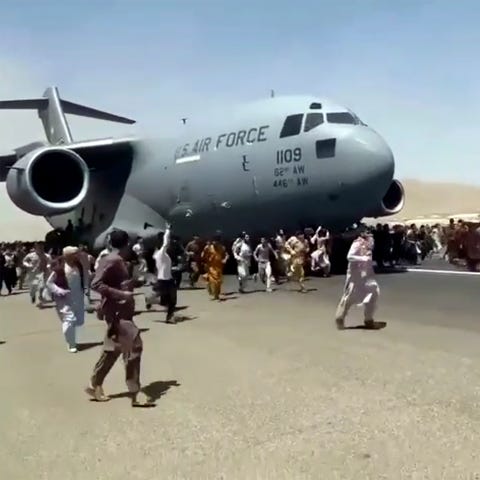 Hundreds of people run alongside a U.S. Air Force 