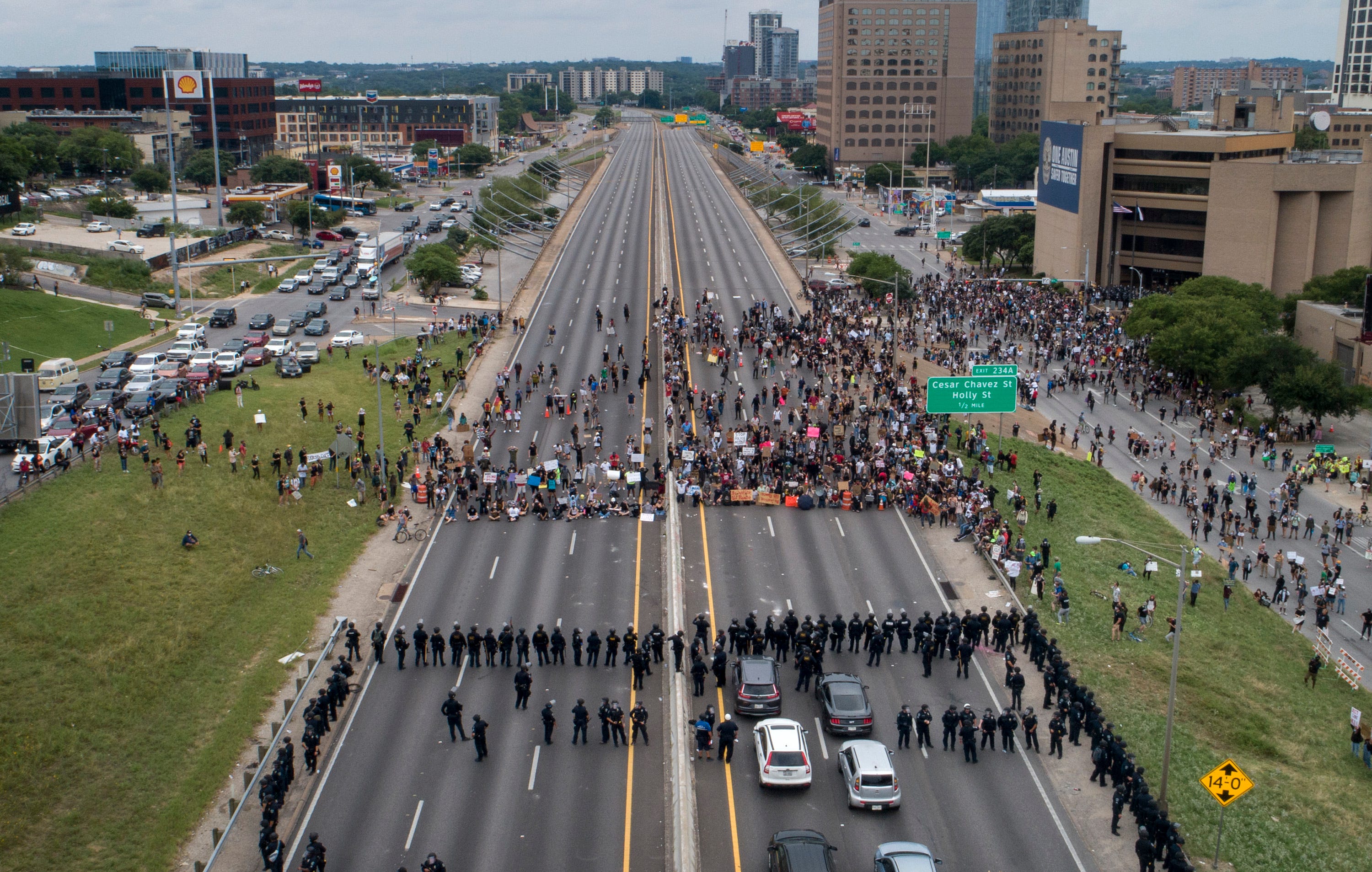 Police face off with protesters who blocked Interstate 35 near the Austin Police Department Headquarters on Sunday May 31, 2020.  Protesters continued to demonstrate against the death of George Floyd while in custody of the Minneapolis police.