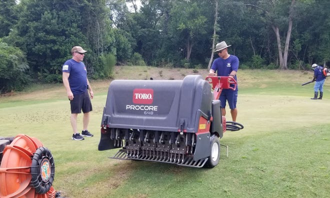 Retired Lt. Col. Ngan Kim drove a Toro 648 procar machine during the project to turn green and then to apply high-grade sand on a August course golf course. They are working on the course as part of the previous Operations Double Eagle Program.