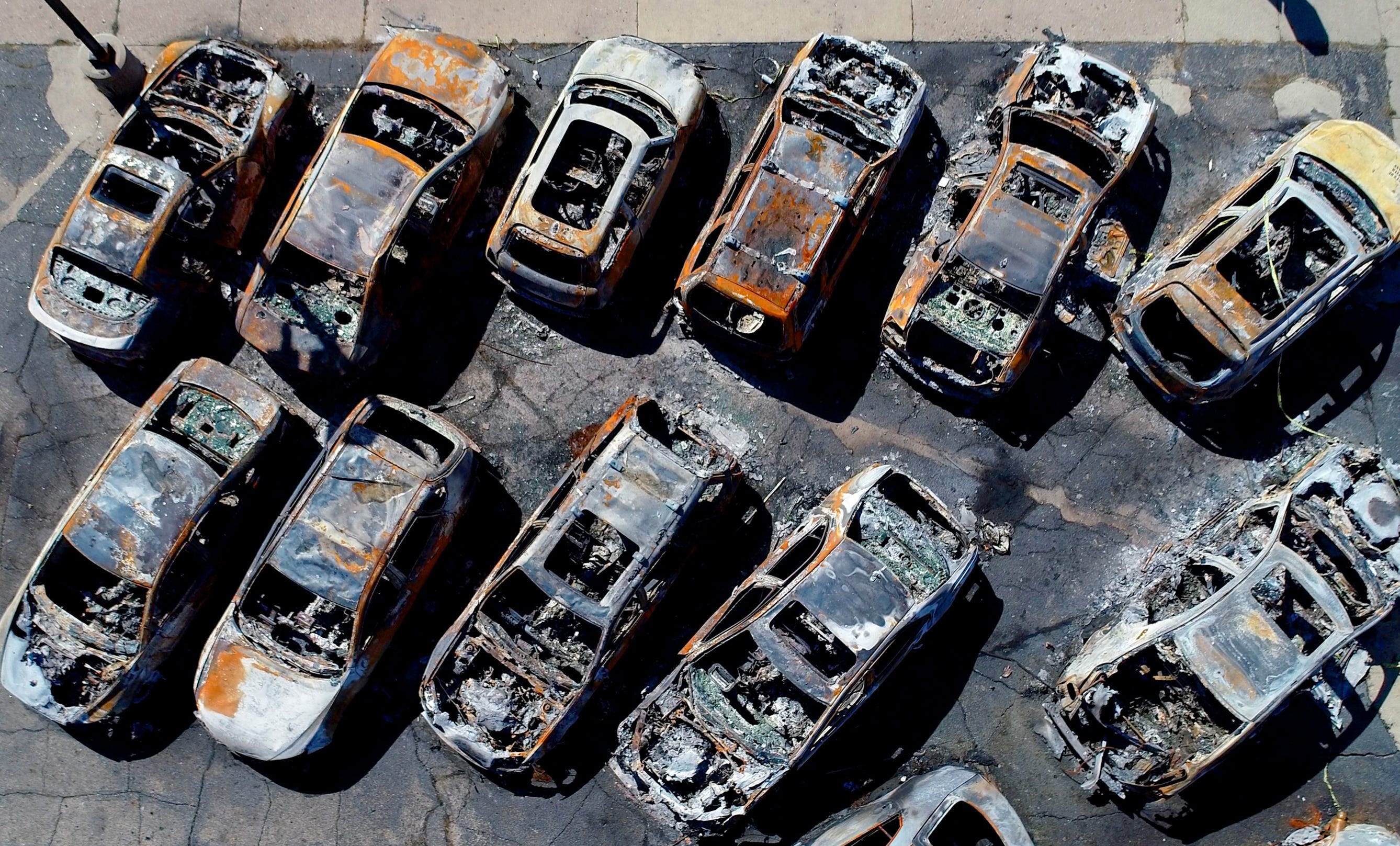 Vehicles sit destroyed after burning at Car Source on Sheridan Road, in Kenosha September 2, 2020. The destruction came as the aftermath consecutive nights of violent protests following of the shooting of Jacob Blake.