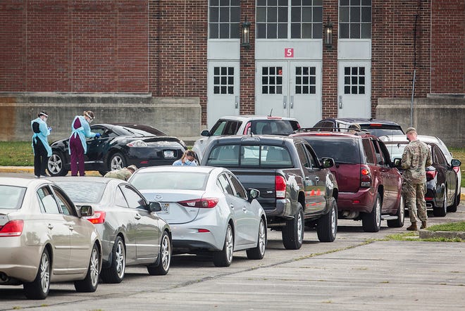 Dozens of drivers line up for a drive thru COVID-19 vaccine and testing clinic outside of the Muncie Fieldhouse Tuesday, Aug. 17, 2021. The Indiana State Department of Health will offer both at the Muncie Fieldhouse, with no appointment necessary, through Aug. 18.