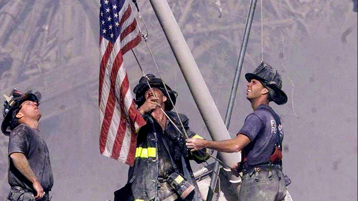 Firefighters raise a flag at Ground Zero following the attack on the World Trade Center on Sept. 11, 2001.