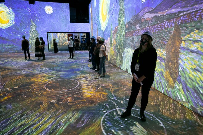 People look on during a preview tour of the Immersive Van Gogh exhibit at the Lighthouse Artspace in Scottsdale on August 17, 2021. The exhibit opens to the public on August 26, 2021.