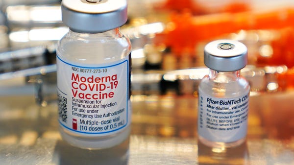 Vials of Moderna and Pfizer COVID-19 vaccines are 