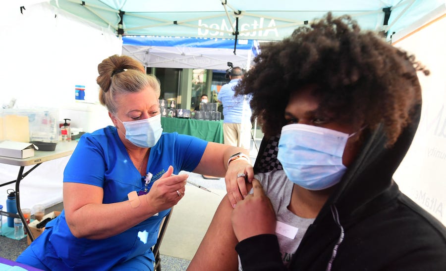 Registered Nurse Amy Berecz-Ortega from AltaMed Health Services administers the Pfizer Covid-19 vaccine in Los Angeles, California on August 17, 2021.