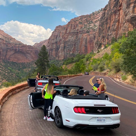 Tourists stop their car in front of the Great Arch