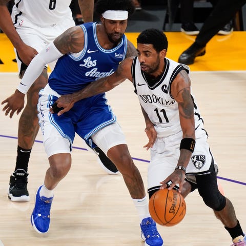 Nets guard Kyrie Irving (11) drives to the basket 