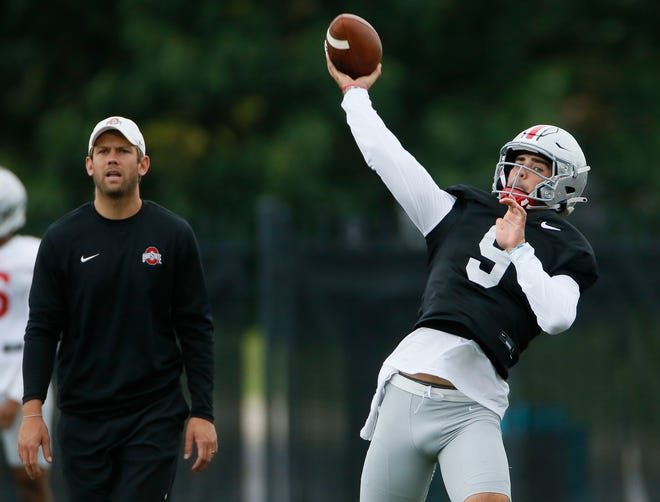 Ohio State Buckeyes quarterbacks coach Corey Dennis watches Jack Miller III throw during football training camp at the Woody Hayes Athletic Center in Columbus on Wednesday, Aug. 18, 2021. 