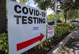 People line up in their cars to get a free COVID-19 test at a site outside the Gardens Branch Library in Palm Beach Gardens, Florida on August 18, 2021. The site is open 7 days a week from 9 am. to 5 pm. 
