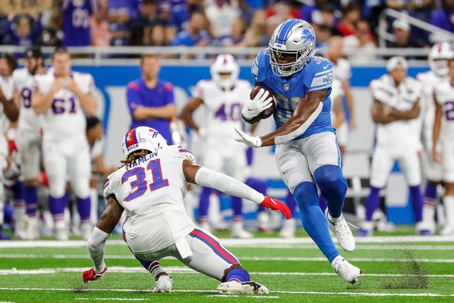 Detroit Lions running back Dedrick Mills (36) runs against Buffalo Bill's safety Damar Hamlin (31) during the second half of the preseason game at Ford Field in Detroit last Friday.
