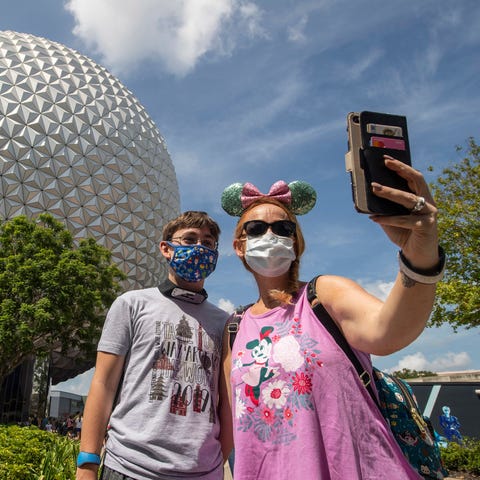 Guests stop for a selfie in front of Spaceship Ear