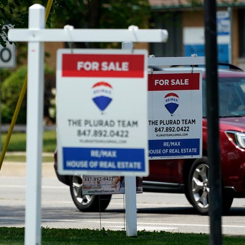 "For Sale" signs are seen outside a home in Glenvi