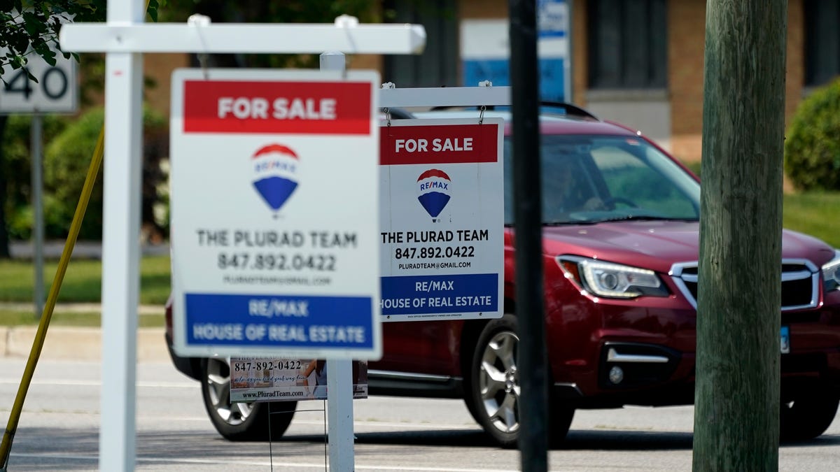 "For Sale" signs are seen outside a home in Glenview, Illinois