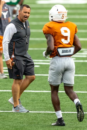 New Texas head coach Steve Sarkisian speaks to wide receiver Al'Vonte Woodard during a practice last week. Sarkisian, who called the plays for Alabama as the Crimson Tide's offensive coordinator the last two years, also will call the offensive plays for the Longhorns.