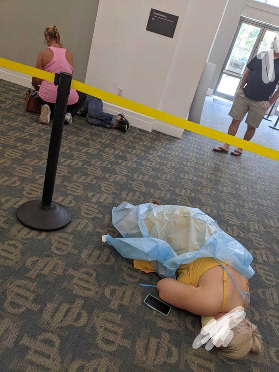 People lying on the floor while waiting for monoclonal therapy at Jacksonville's downtown library location on Wednesday, Aug. 19. Lopez obscured the faces of the people before sharing the image.