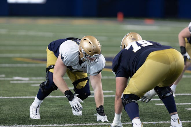 Sophomore defensive tackle Rylie Mills, left, is making a case to find a significant role on Notre Dame's defense. Pictured, Mills lines up against offensive tackle Tosh Baker in an April spring practice.