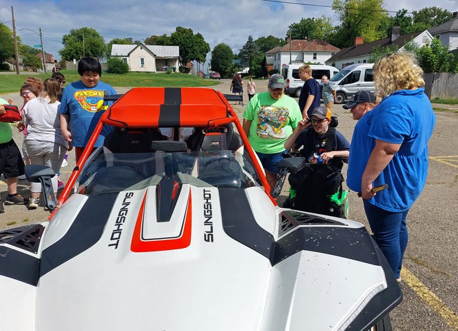 Goodwill Dream Retreat campers check out a Slingshot car owned by Ross County Treasurer Dave Jeffers on Aug. 18, 2021.