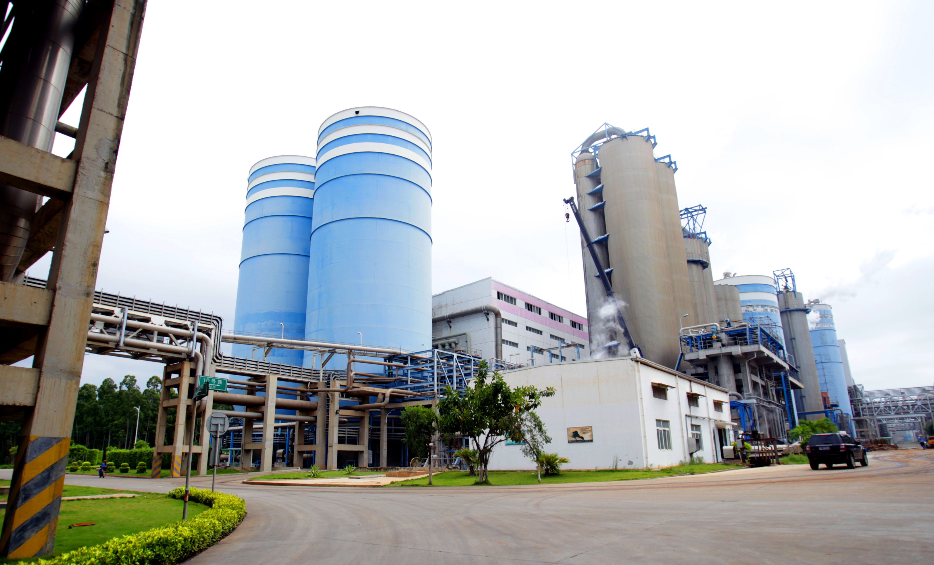 The area including the pulp making mill is seen. The left building is bleached pulp tower and right one is bleaching stage at the APP's (Asia Pulp and Paper) Hainan pulp and paper mill in Yangpu, China. The complex includes the biggest pulp mill in China.
