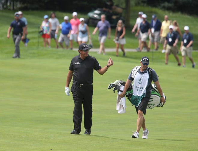 Phil Mickelson approaches the green on 13 and acknowledges the applause from the gallery during the opening round of the Northern Trust Golf Tournament part of the PGA Tour being played at Liberty National Golf Club in Jersey City on August 19, 2021.