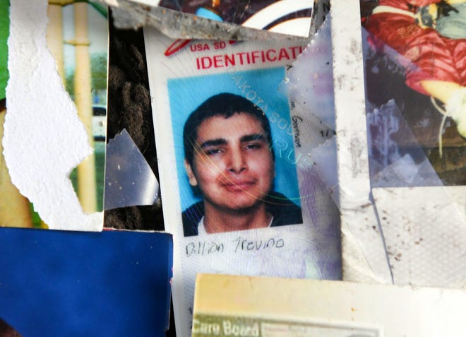Dillion Trevino's driver's license with his most current photo sits among a pile of old family photos from his childhood on Wednesday, August 18, 2021 at his family home in Sioux Falls.