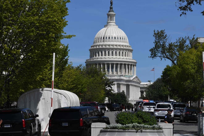 Police investigate a possible bomb threat near the US Capitol and Library of Congress in Washington, DC, on August 19, 2021. Police said Thursday a suspicious vehicle was being investigated for possible explosives and that people were told to leave the area. 