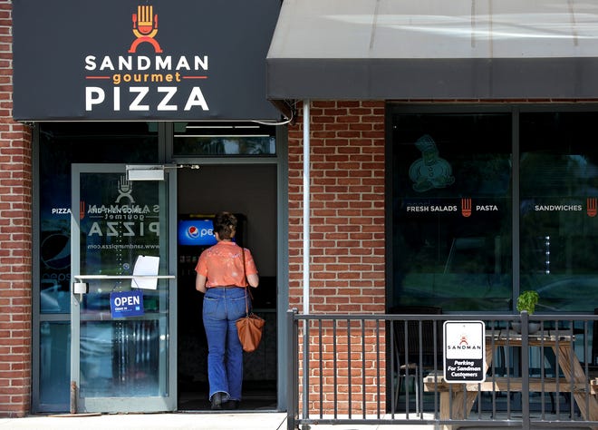 Sandman Pizza, formerly Sandman Gourmet Pizza, recently reopened its recast flagship Westerville store after a prolonged shutdown because of COVID-19. A customer enters the restaurant on Friday, August 20, 2021.