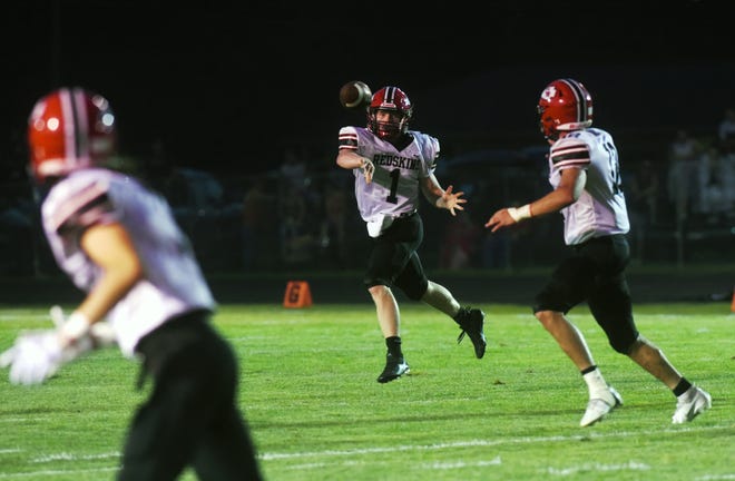 Coshocton quarterback Kobe Rust throws a pass to Isaac Shook against Ridgewood. Rust signed to play football for Division II Ashland and will move from quarterback to wide receiver for the Eagles.