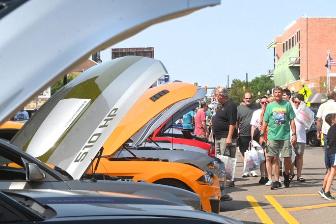 Ford Mustangs line 9 Mile Road for the famed Mustang Alley in Ferndale on Saturday, August 21, 2021 for the Woodward Dream Cruise.