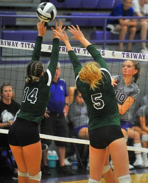 Triway's Clowie Flinner sends a kill past Smithville's Brooke Fatzinger (5) and Sydney Shane (14).