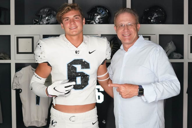 Nease tight end Grant Stevens, left, poses with UCF head coach Gus Malzahn on his official visit.