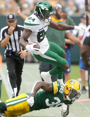 Green Bay Packers safety Innis Gaines (38) pushes New York Jets wide receiver Corey Davis (84) out of bounds following a reception during their preseason football game on Saturday, August 21, 2021, at Lambeau Field in Green Bay, Wis.  Wm. Glasheen USA TODAY NETWORK-Wisconsin