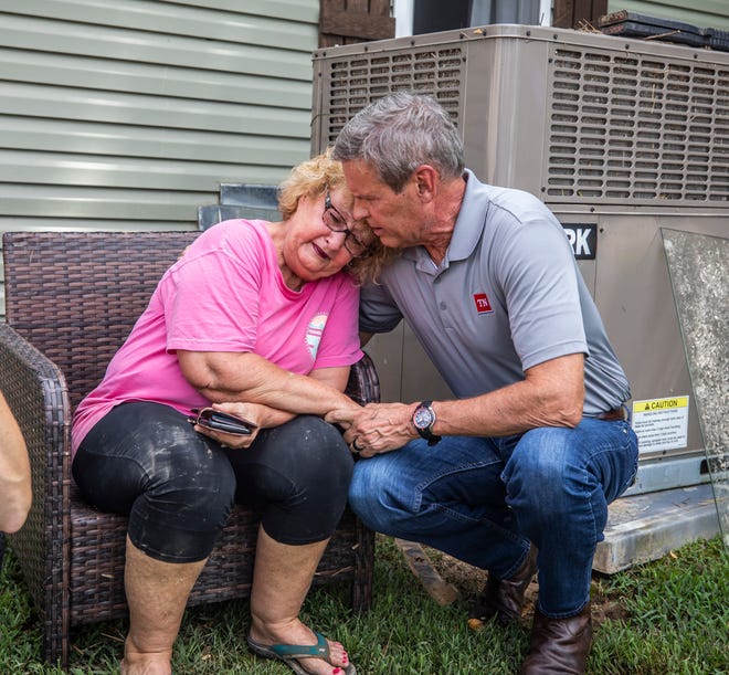 Governor Lee comforts Shirley Foster who had just learned a friend of hers died in the flooding in Waverly Sunday, August 22, 2021.