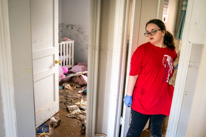 Vanessa Yates checks the damage inside her home in Waverly, Tenn., Sunday, August 22, 2021. Fifteen inches of rain caused extensive flooding in the County town of Humphreys.