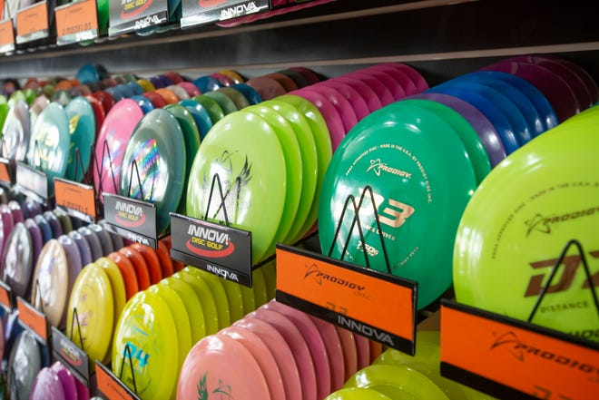 Disc golf supplies are for sale during the grand opening of the Flight Factory disc golf shop on Tippin Avenue on Saturday.