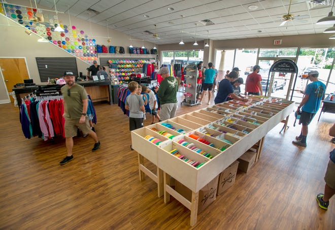 Shoppers check out the Flight Factory disc golf shop on Tippin Avenue in Pensacola during the grand opening Saturday.