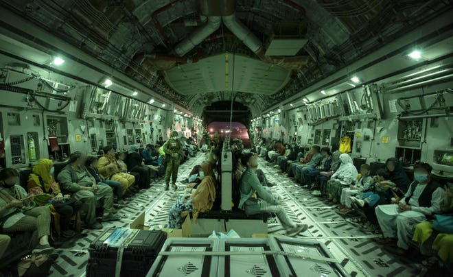 This handout photo, taken on Aug. 20 and received Aug. 22, 2021 from the Australian Defence Force, shows people onboard the Royal Australian Air Force C-17A Globemaster at Hamid Karzai International Airport in Kabul.