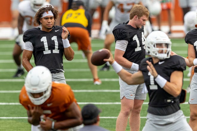 Casey Thompson, left, watches as Hudson Card throws during an open practice session for fans last week. Texas coach Steve Sarkisian is expected to announce one as the starter for the Sept. 4 season opener against Louisiana.