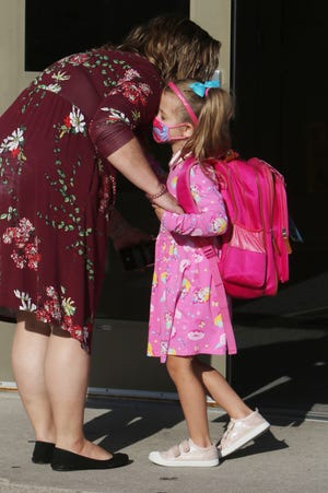 Amanda Sorenson drops off her daughter, Lydia, 5, for her first day of kindergarten during the first day of school for Burlington School District students Aug. 23, 2021, at North Hill Elementary School. The district began the school year without a mask mandate but reinstated it later in the year following a rise in cases. Several community members addressed the school board Monday requesting that the district lift the mandate.
