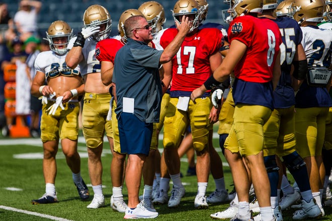 Notre Dame head coach Brian Kelly talks to his players at football practice Thursday, Aug. 19, 2021, at Notre Dame Stadium.