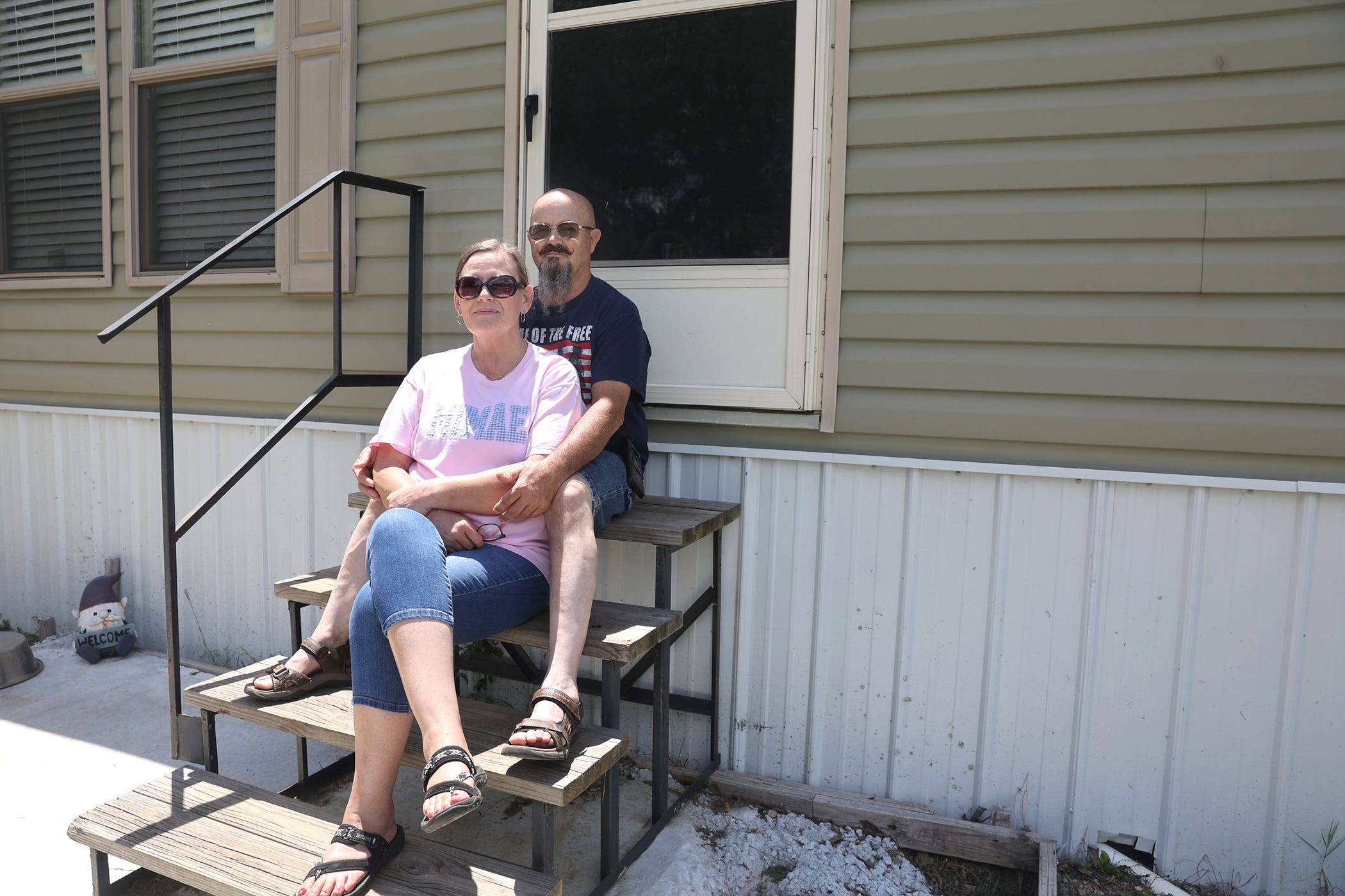 Susan Marsh and her husband Gene sit on the steps of their home in Davisboro Georgia.