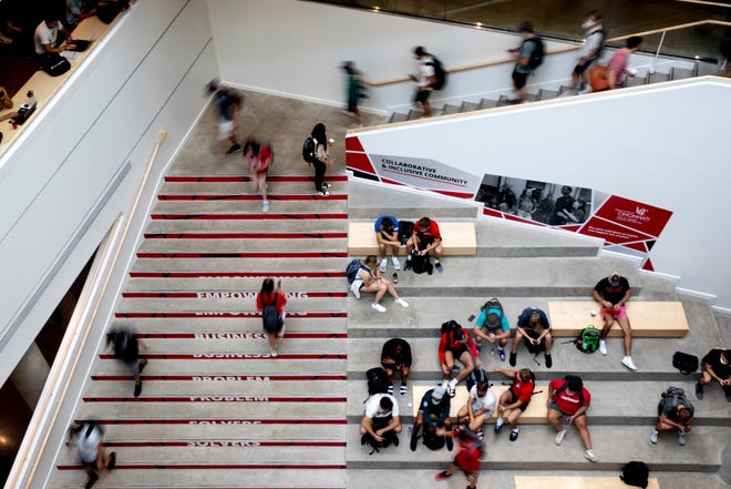 Students walk inside the Lindner College of Business on the University of Cincinnati campus in this photo from August 2021.