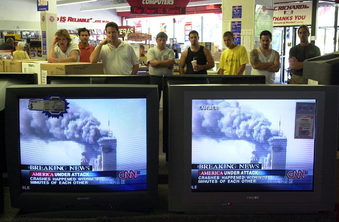 PC Richards customers in Yonkers, New York, watch news of a terrorist attack on the World Trade Center on September 1, 2001.