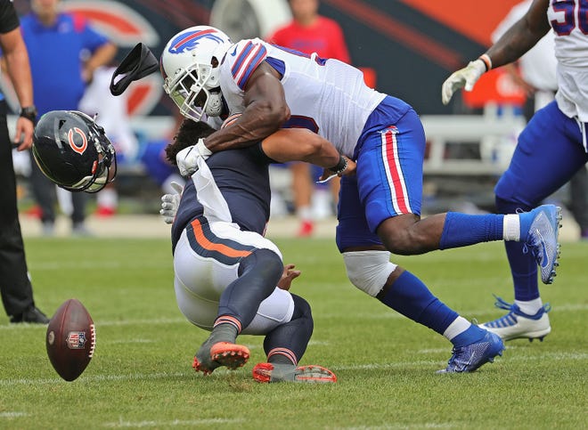 Justin Fields #1 of the Chicago Bears is hit by Andre Smith #59 of the Buffalo Bills during a preseason game at Soldier Field on August 21, 2021 in Chicago, Illinois. The Bills defeated the Bears 41-15.