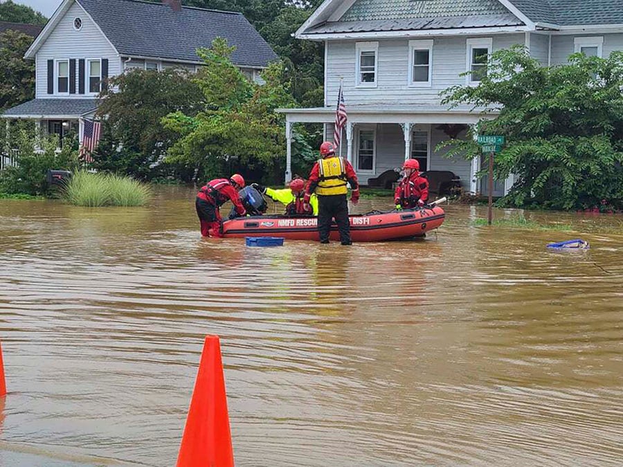 Emergency personnel and first responders help residents Aug. 22 after heavy rains from Henri flooded Helmetta, N.J.
