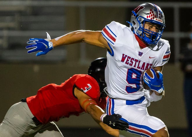 Westlake Chaparrals (9) Jaden Greathouse looks for room to run against Bowie Bulldogs(3) Jason Gaines in the second half of the game at Burger Stadium in South Austin on Thursday, November 12, 2020.