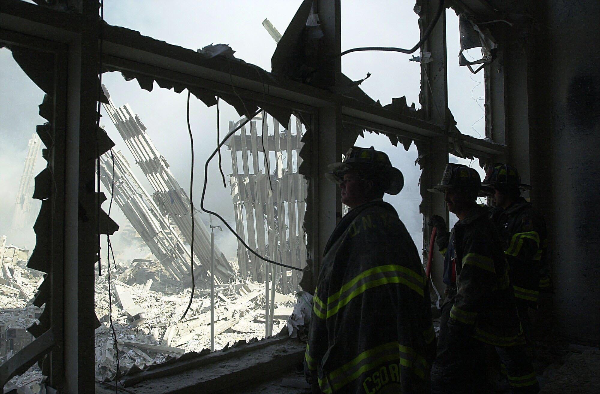 New York City Firefighters look at the remains of the World Trade Center on Sept. 11, 2001.