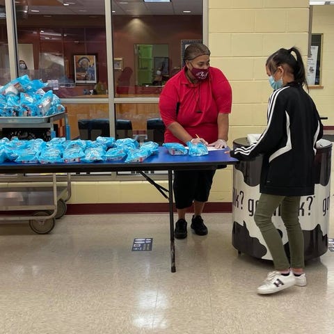 Students pick up cereal breakfast before school at