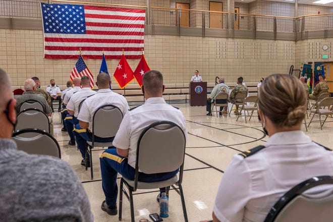 Class 64 of the N.D. Officer Candidate School listens as the keynote speaker, Brig. Gen. Jackie Huber, N.D. National Guard deputy adjutant general, renders remarks and offered advice to the graduates during the graduation ceremony, Aug. 21, 2021, at the 164th Regiment Regional Training Institute.