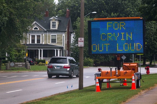 An electronic sign placed along MacArthur Boulevard next to the entrance to Washington Park displays the message "For Cryin Out Loud Slow Down" to remind motorists to slow down while traveling through the area. Sgt. Jeff Royer, traffic services supervisor with the Springfield Police Department, oversees the placement and messages of the signs. "I hope that it helps and people will slow down," said Royer of the humorous messages he has used to grab motorists' attention. [Justin L. Fowler/The State Journal-Register]